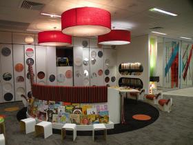 Children's area in library with  stools and bookshelves