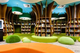 Children's library with bookshelves and seating in the design of a forest