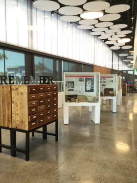 Library local studies area with objects displayed in glass cabinets