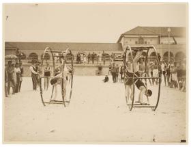 Women standing and turning in giant wheels along Bondi Beach