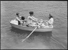 Man, woman and child in a row boat