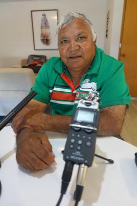 Warren Clark sitting in front of a microphone at time of interview.