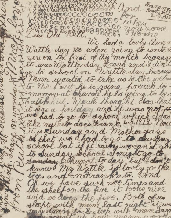 A letter written in cursive in a child's hand, with blots of ink and many Xs and Os in the margins.