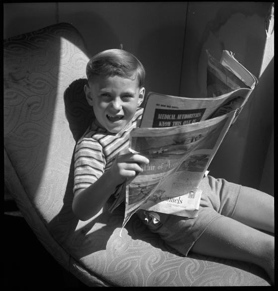 Jimmy Lee, model, 6 years old, reading newspaper, January 1946 / photographed by Max Dupain