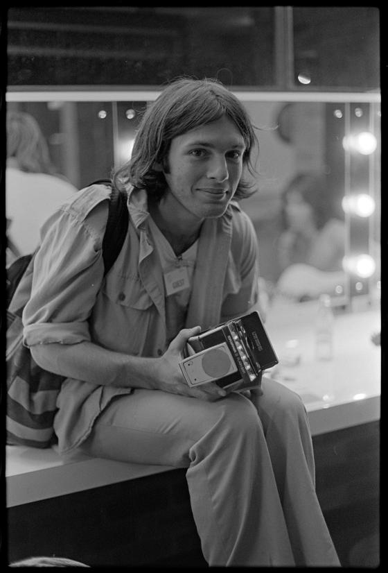 Jon Lewis with Polaroid camera, c 1976. Photo by William Yang
