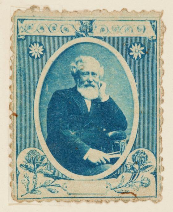 An old blue stamp with a portrait of a bearded man.