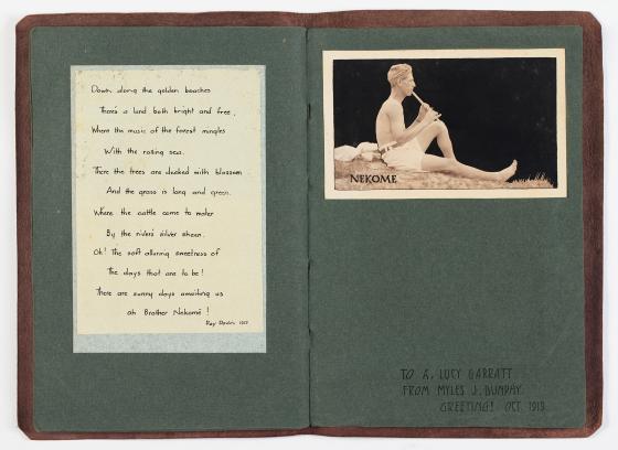 An open booklet featuring a handwritten poem and a photo of a man playing a flute.