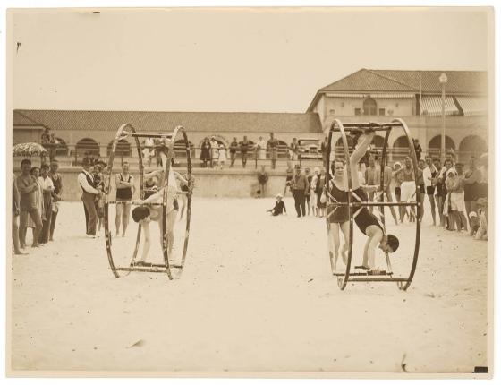 Women standing and turning in giant wheels along Bondi Beach
