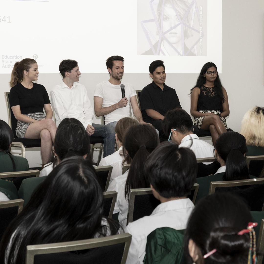 A panel of five students talking to an audience