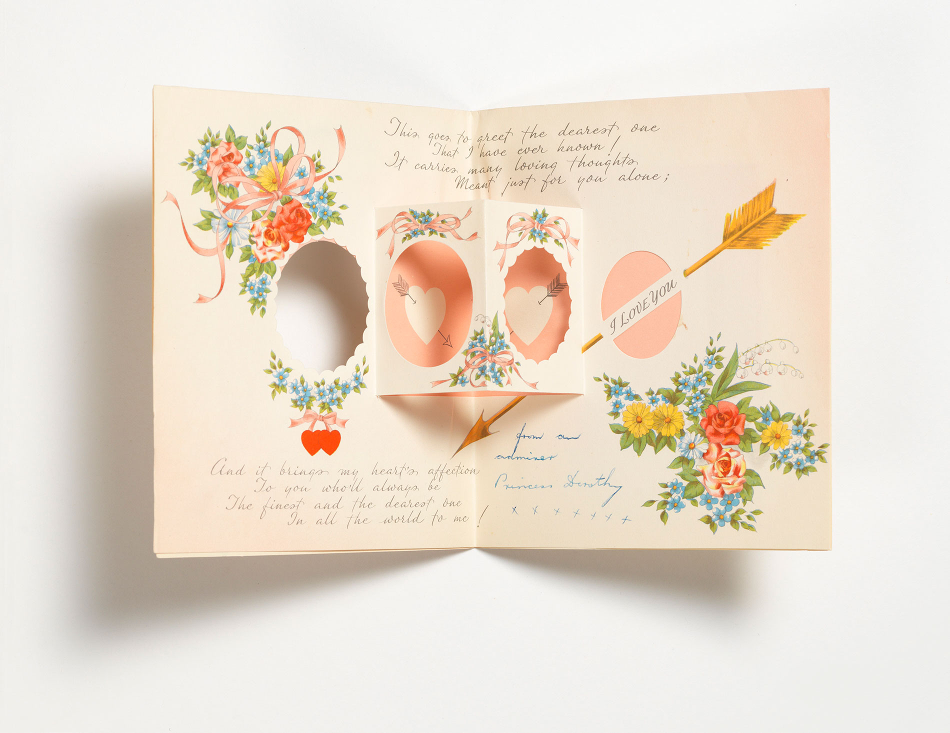 The inside of a Valentine's Day greeting card, with a pop-up feature, a printed romantic message and flower graphics.
