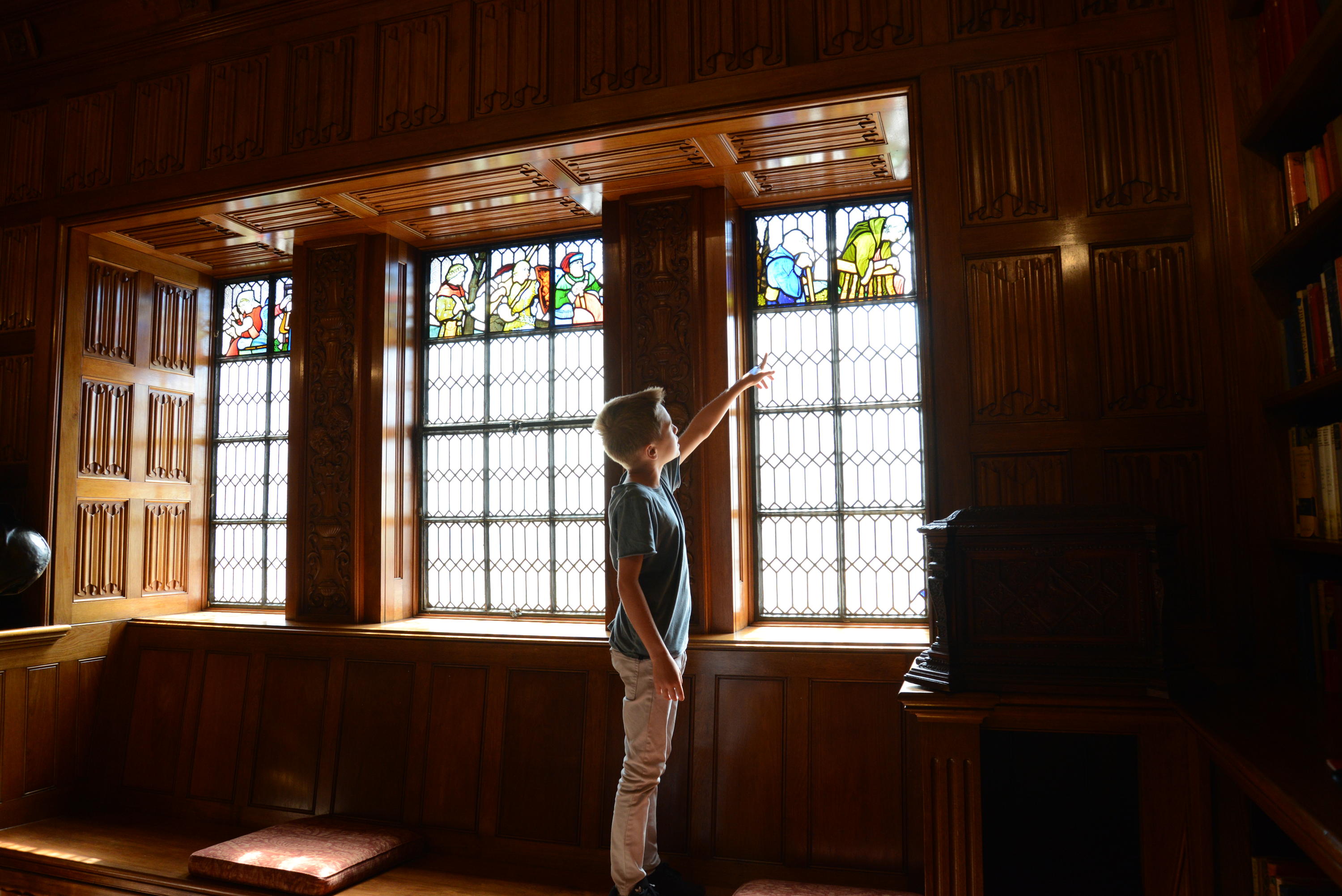 A child looking through the stained glass windows in the State Library Shakespeare Room