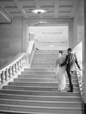 Image of a bride and groom on marble staircase.