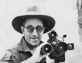 Black and white photograph of man with moving picture camera