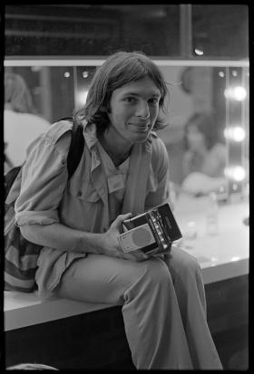 Jon Lewis with Polaroid camera, c 1976. Photo by William Yang