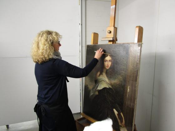 Julia Sharp, Conservation Manager, David Stein &amp; Co, works on the painting 